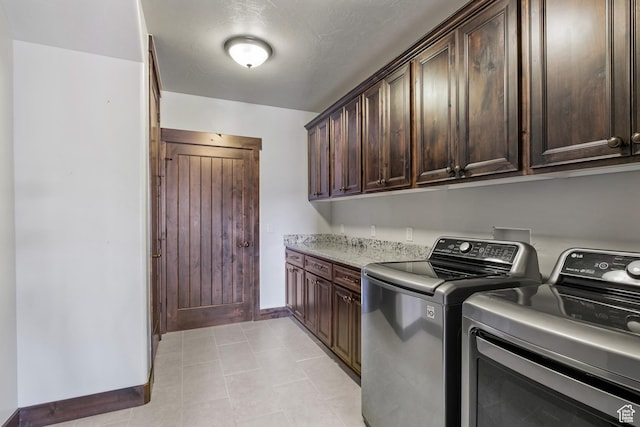washroom with cabinets and washer and dryer