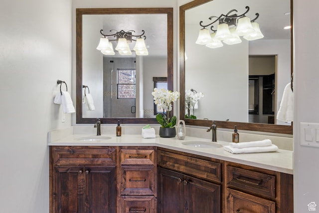 bathroom with a shower with door and vanity