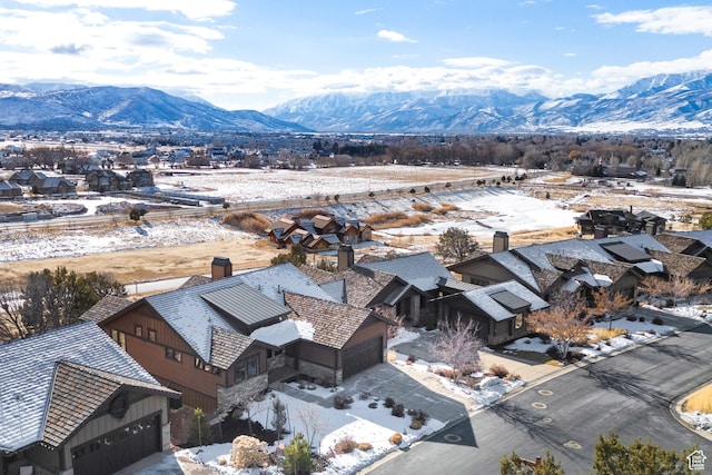 snowy aerial view featuring a mountain view
