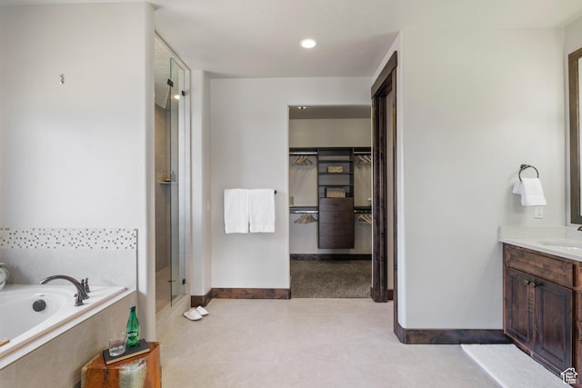 bathroom featuring plus walk in shower and vanity