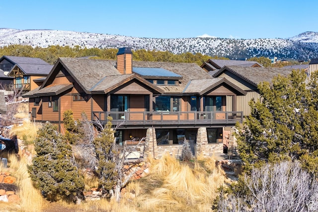 back of property with a mountain view