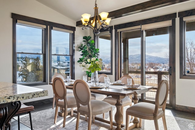 dining space featuring a mountain view, a notable chandelier, and vaulted ceiling