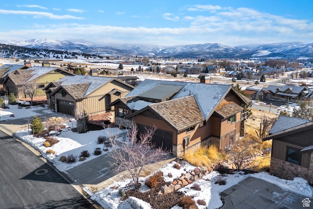 snowy aerial view with a mountain view