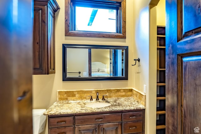 bathroom with toilet and vanity
