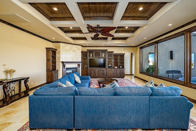 living room featuring coffered ceiling, ceiling fan, a fireplace, crown molding, and beam ceiling