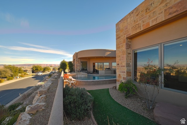 view of swimming pool featuring a mountain view and a patio