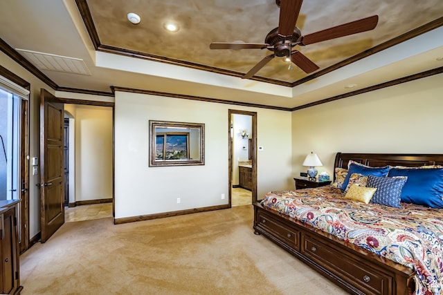 carpeted bedroom featuring ceiling fan, ornamental molding, connected bathroom, and a raised ceiling