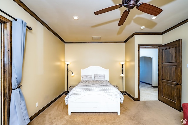 carpeted bedroom featuring ceiling fan and ornamental molding