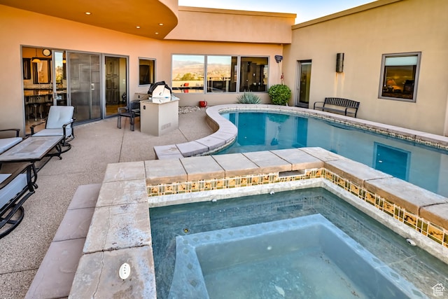 view of swimming pool with an in ground hot tub