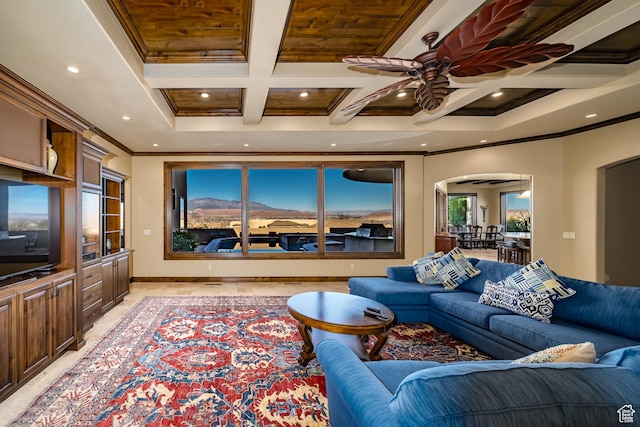 living room featuring ceiling fan, ornamental molding, beam ceiling, and coffered ceiling