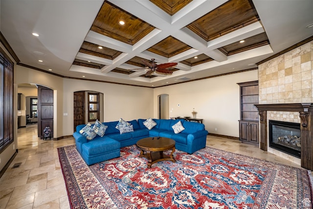 living room featuring beamed ceiling, a fireplace, wooden ceiling, crown molding, and coffered ceiling