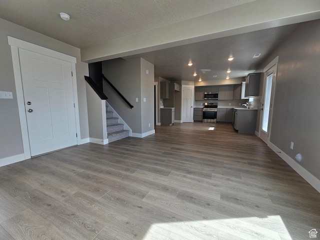1447 W 500 N Lot 17, Springville, UT 84663 - unfurnished living room with baseboards, stairs, and light wood finished floors