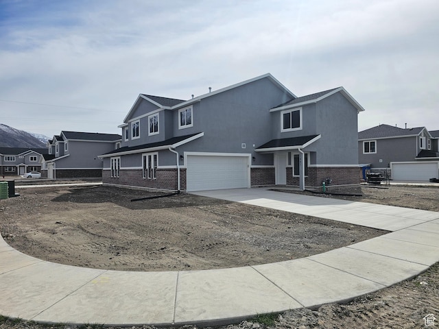 1447 W 500 N Lot 17, Springville, UT 84663 - traditional-style home featuring brick siding, stucco siding, an attached garage, and concrete driveway