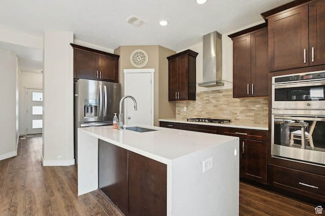 6343 W 7900 S, West Jordan, UT 84081 - kitchen featuring a center island with sink, stainless steel appliances, backsplash, dark wood-type flooring, and wall chimney exhaust hood