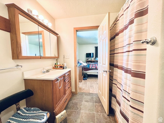 19600 N 8250 E, Mount Pleasant, UT 84647 - bathroom featuring curtained shower, a textured ceiling, ensuite bath, and vanity