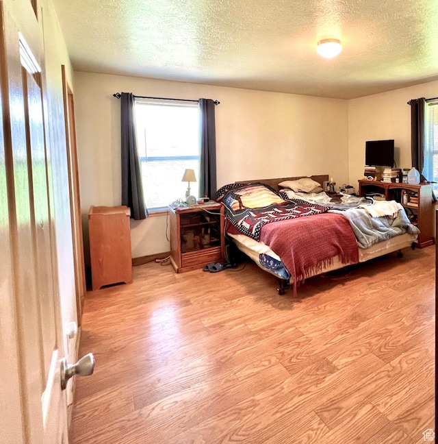 19600 N 8250 E, Mount Pleasant, UT 84647 - bedroom featuring a textured ceiling and wood finished floors