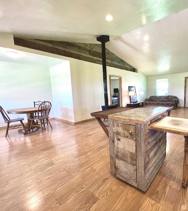 19600 N 8250 E, Mount Pleasant, UT 84647 - kitchen featuring baseboards, a textured ceiling, vaulted ceiling, and light wood finished floors
