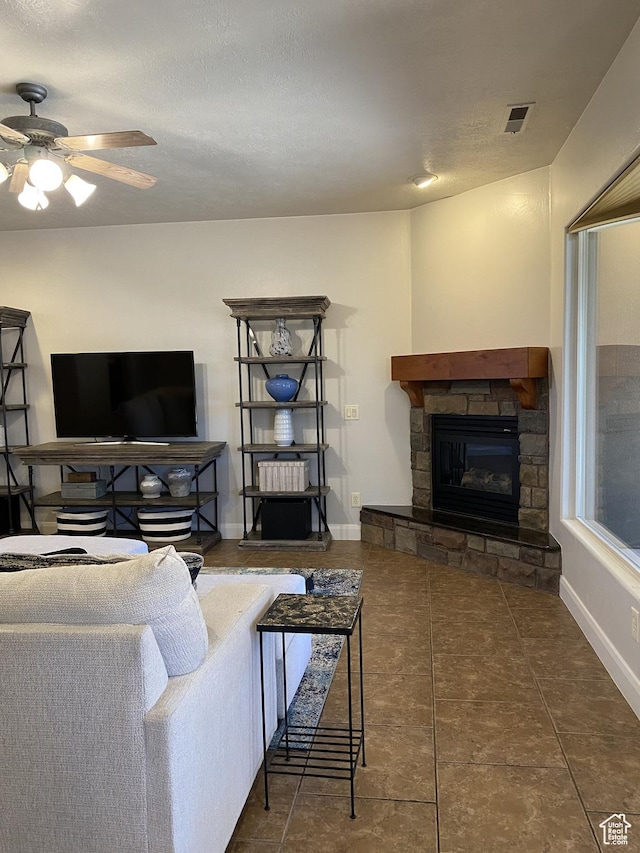 1918 S Mojave Dr, Washington, UT 84780 - living room featuring ceiling fan, dark tile patterned flooring, and a fireplace
