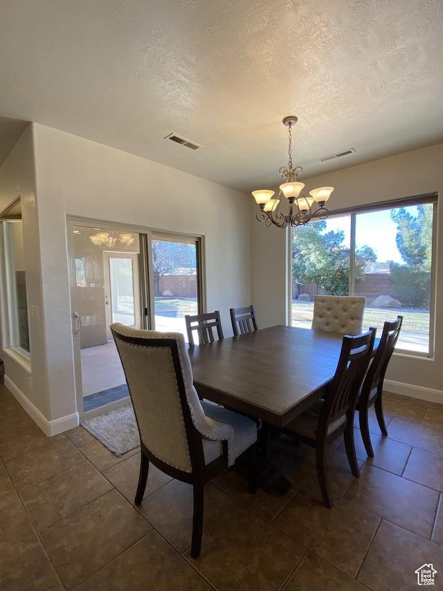 1918 S Mojave Dr, Washington, UT 84780 - tiled dining room with a textured ceiling and a chandelier