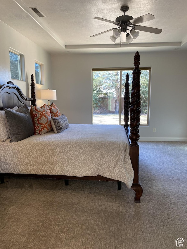1918 S Mojave Dr, Washington, UT 84780 - carpeted bedroom with ceiling fan, access to exterior, a tray ceiling, and a textured ceiling
