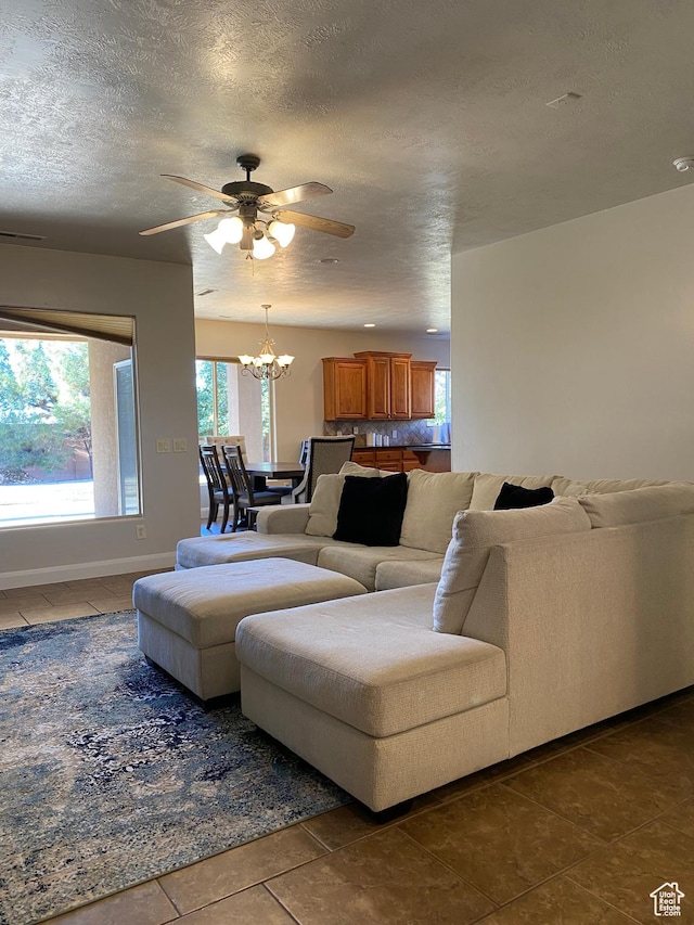 1918 S Mojave Dr, Washington, UT 84780 - tiled living room with ceiling fan with notable chandelier and a textured ceiling