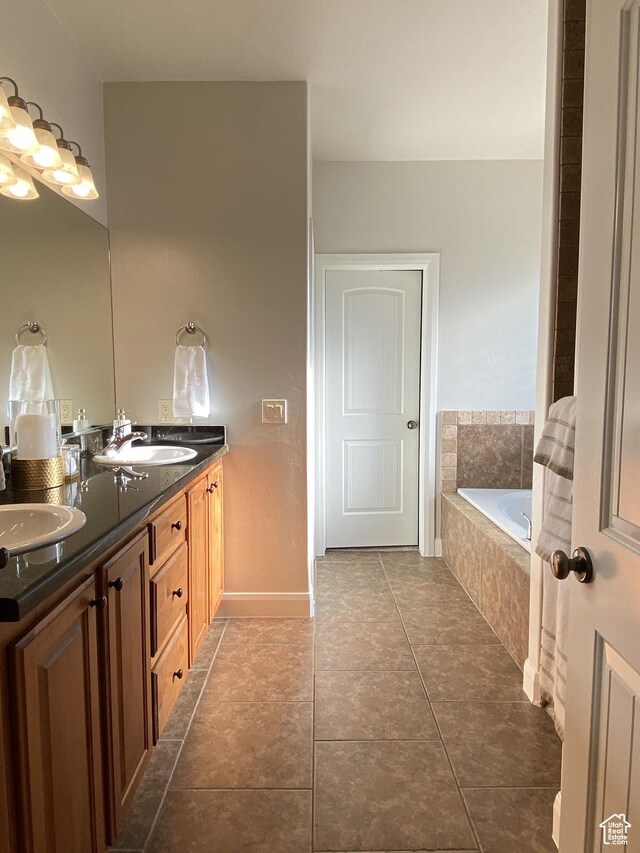 1918 S Mojave Dr, Washington, UT 84780 - bathroom with vanity, tile patterned flooring, and a relaxing tiled tub