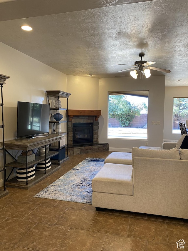 1918 S Mojave Dr, Washington, UT 84780 - living room with ceiling fan, a fireplace, and a textured ceiling