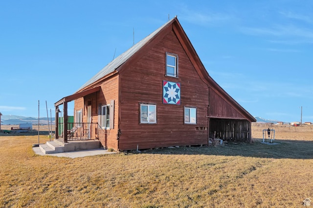 320 S 800 W, Lewiston, UT 84320 - view of side of property featuring an outdoor structure, a yard, and a mountain view
