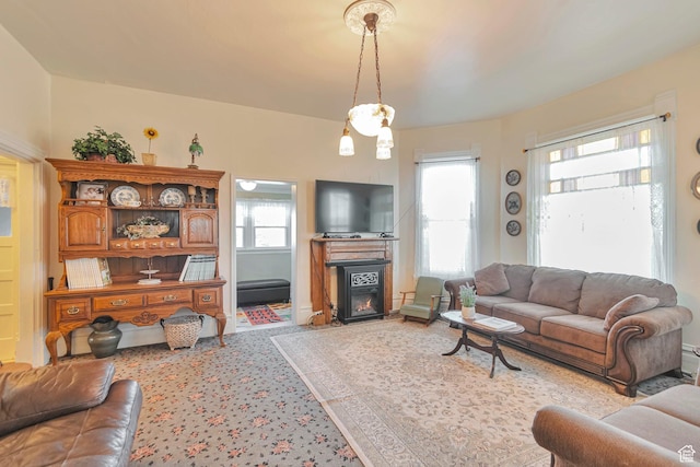 320 S 800 W, Lewiston, UT 84320 - living area with a glass covered fireplace, a wealth of natural light, and light colored carpet