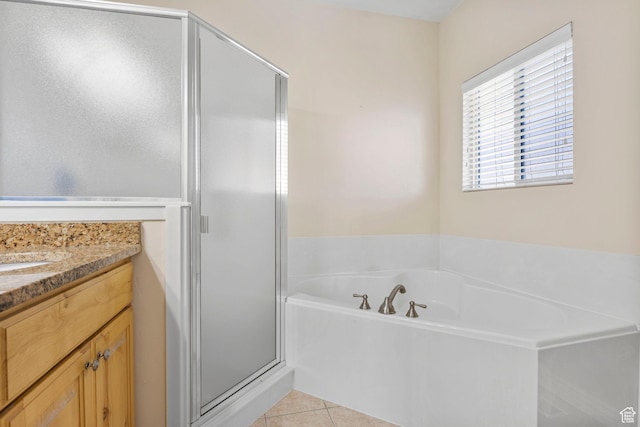 bathroom featuring shower with separate bathtub, vanity, and tile patterned flooring