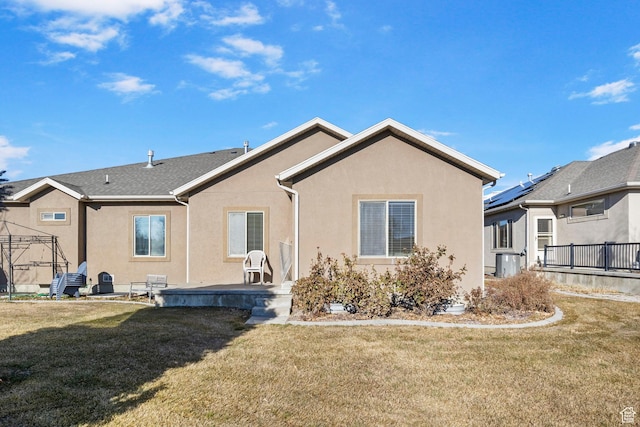 rear view of property featuring a gazebo, a yard, and central AC