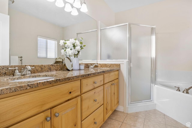 bathroom with vanity, tile patterned flooring, a notable chandelier, and plus walk in shower