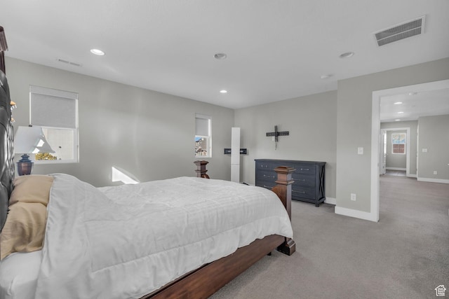 bedroom featuring light carpet