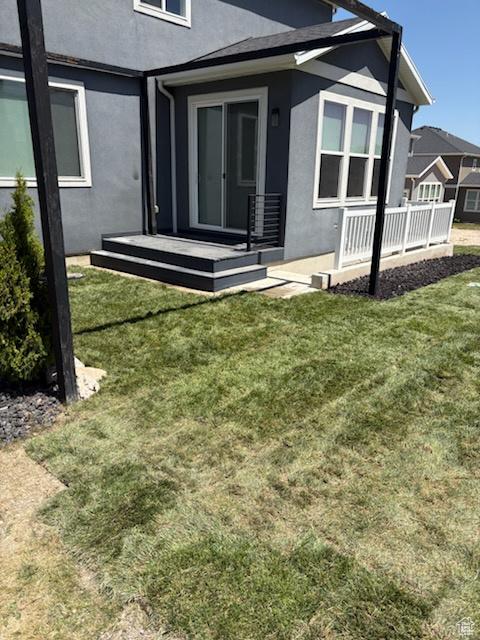 1907 S Centennial Blvd, Saratoga Springs, UT 84045 - back of house with stucco siding and a yard