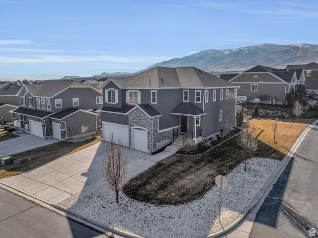 view of front of property with a garage and a mountain view