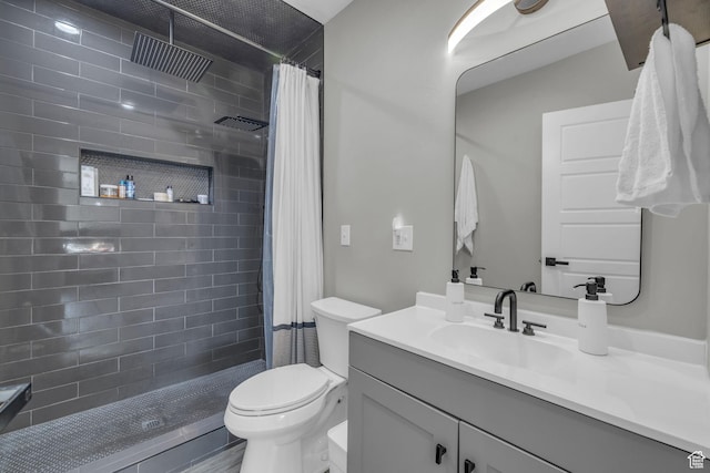 bathroom with toilet, vanity, and curtained shower