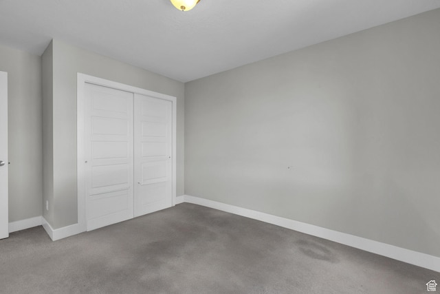 unfurnished bedroom with a closet and carpet