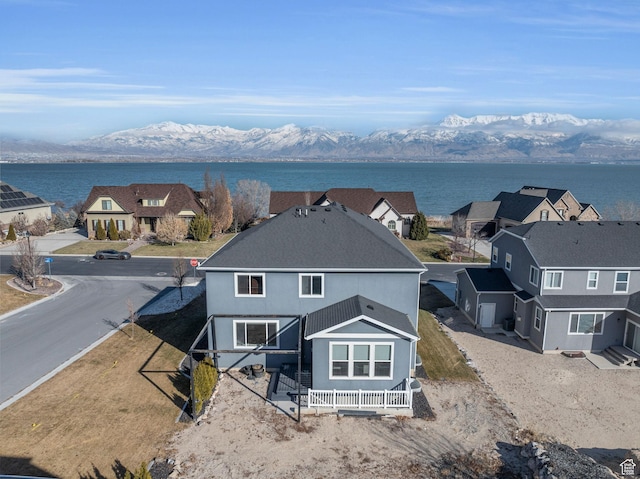 rear view of property featuring a water and mountain view