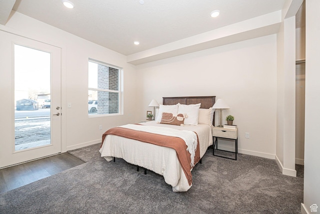 bedroom with access to exterior and dark carpet
