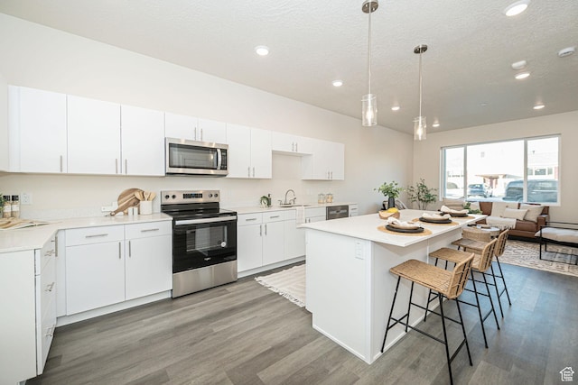kitchen with sink, white cabinets, and stainless steel appliances