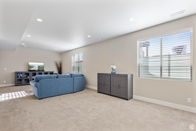 living room featuring light colored carpet, baseboards, and visible vents