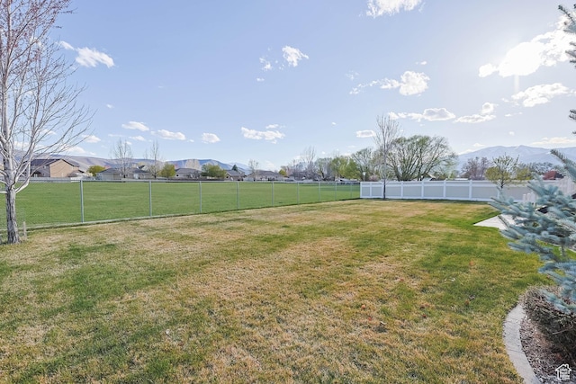 view of yard with fence and a mountain view