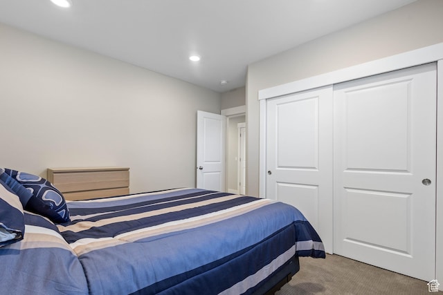 carpeted bedroom with a closet and recessed lighting