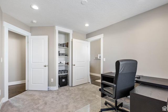 office space featuring recessed lighting, baseboards, and light carpet
