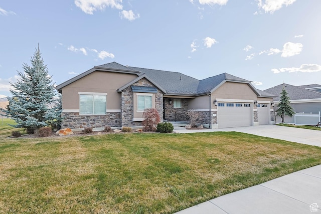 view of front of property with a front lawn, stucco siding, an attached garage, driveway, and stone siding