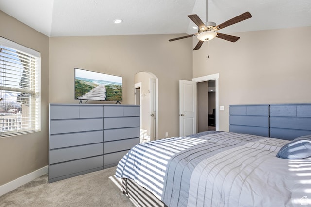 bedroom with arched walkways, baseboards, high vaulted ceiling, ceiling fan, and carpet floors