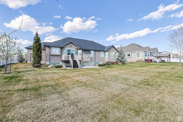 rear view of property with a lawn and a residential view