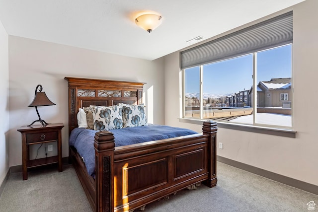 bedroom featuring light carpet, visible vents, and baseboards