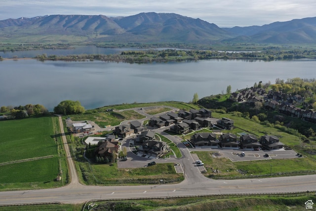 drone / aerial view with a water and mountain view and a residential view
