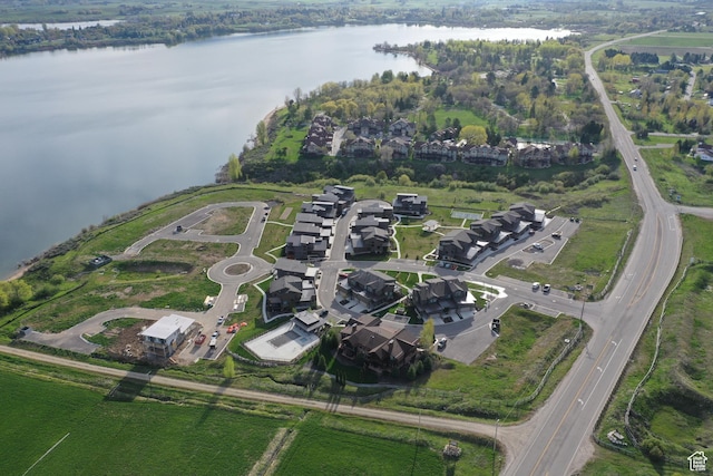 birds eye view of property with a water view and a residential view